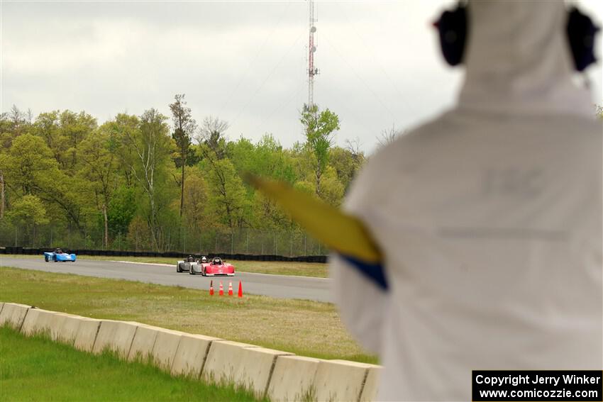 Ben Anderson's, Justin Elder's, Nolan Elder's and Lauren Dueck's Spec Racer Ford 3s come out of turn 3 on lap 1.