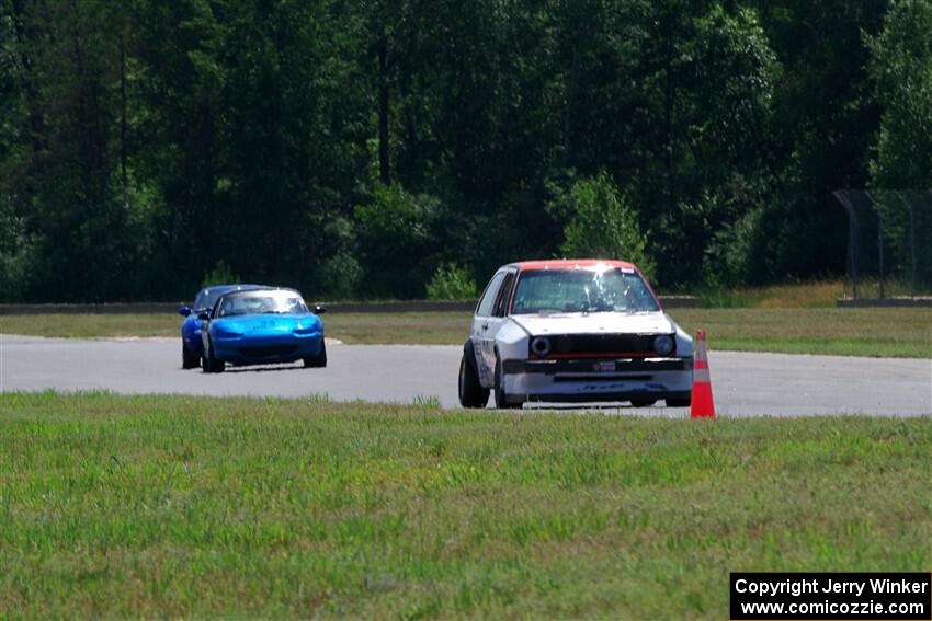 Brooke Fairbanks' H Production VW Golf with Rick Buan's and Luke Allen's Spec Miata Mazda Miatas