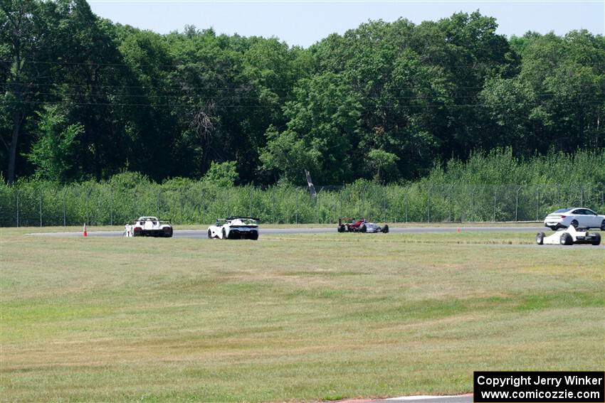 Race Group 4, Formula Cars and Sports Racers, streams through turns 4 and 5 on the pace lap.