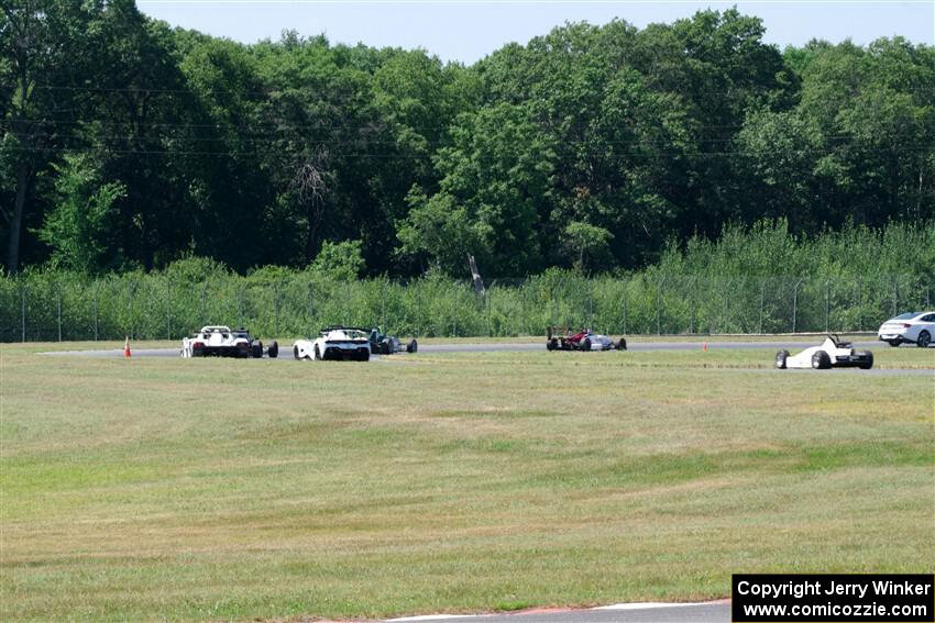 Race Group 4, Formula Cars and Sports Racers, streams through turns 4 and 5 on the pace lap.