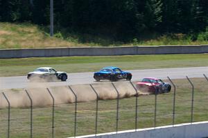 Kyle Greenhill's and Samantha Silver's Spec Miata Mazda Miatas pass Chris Craft's Spec Miata Mazda Miata