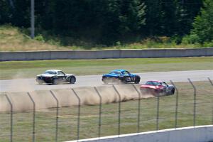 Kyle Greenhill's and Samantha Silver's Spec Miata Mazda Miatas pass Chris Craft's Spec Miata Mazda Miata