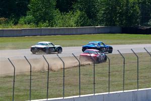 Kyle Greenhill's and Samantha Silver's Spec Miata Mazda Miatas pass Chris Craft's Spec Miata Mazda Miata