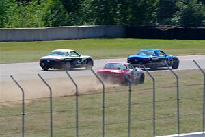 Kyle Greenhill's and Samantha Silver's Spec Miata Mazda Miatas pass Chris Craft's Spec Miata Mazda Miata