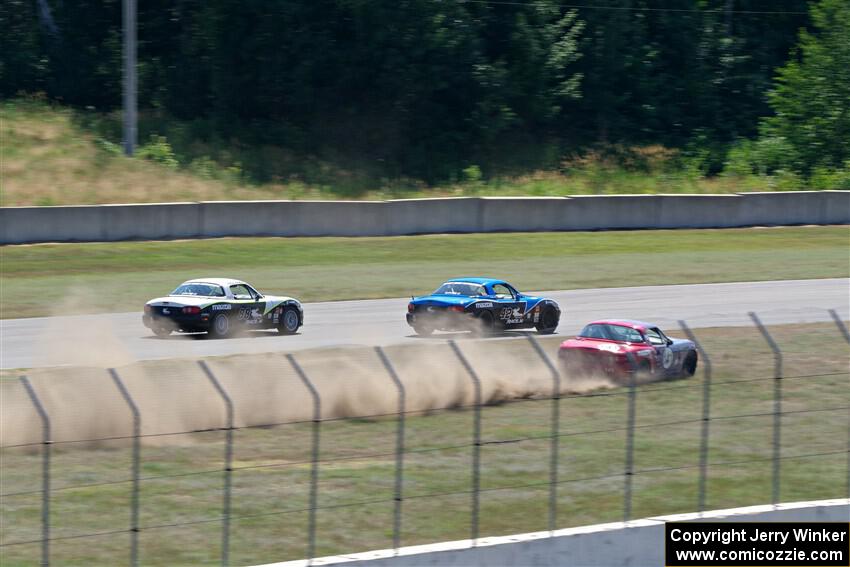 Kyle Greenhill's and Samantha Silver's Spec Miata Mazda Miatas pass Chris Craft's Spec Miata Mazda Miata