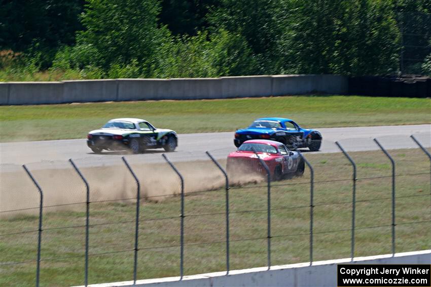 Kyle Greenhill's and Samantha Silver's Spec Miata Mazda Miatas pass Chris Craft's Spec Miata Mazda Miata