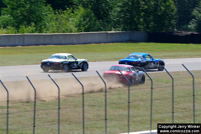 Kyle Greenhill's and Samantha Silver's Spec Miata Mazda Miatas pass Chris Craft's Spec Miata Mazda Miata
