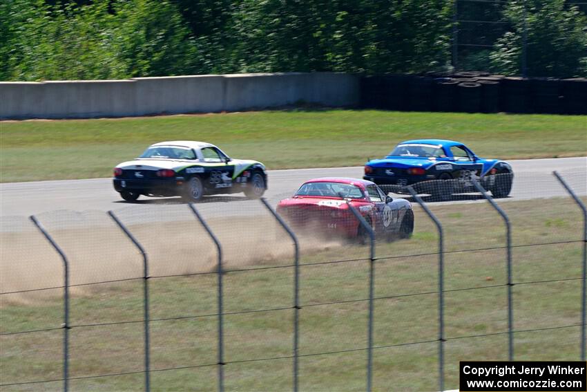 Kyle Greenhill's and Samantha Silver's Spec Miata Mazda Miatas pass Chris Craft's Spec Miata Mazda Miata