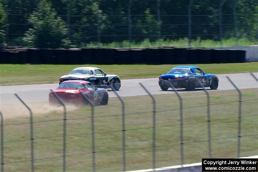 Kyle Greenhill's and Samantha Silver's Spec Miata Mazda Miatas pass Chris Craft's Spec Miata Mazda Miata