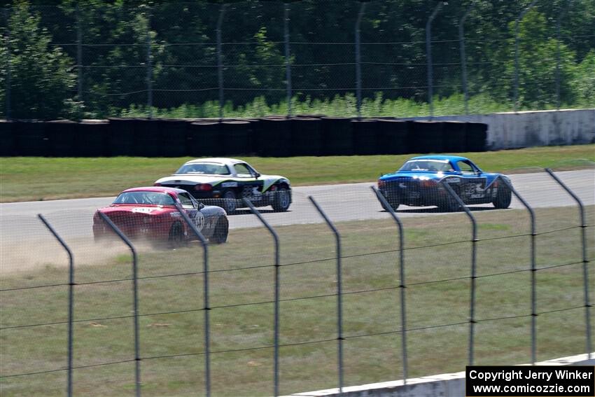 Kyle Greenhill's and Samantha Silver's Spec Miata Mazda Miatas pass Chris Craft's Spec Miata Mazda Miata