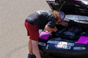 Andrew Rausch checks under the hood of Sophie Jones' Spec Miata Mazda Miata.