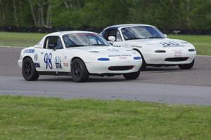 (98) Andrew Wolff's STL Mazda Miata and (36) Craig Silver's Spec Miata Mazda Miata go side-by-side