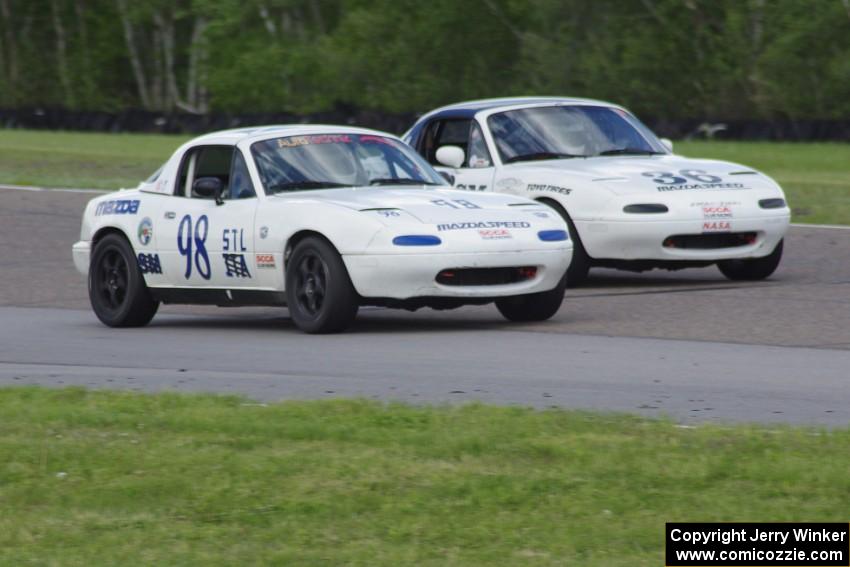 (98) Andrew Wolff's STL Mazda Miata and (36) Craig Silver's Spec Miata Mazda Miata go side-by-side