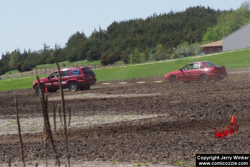 Peter Battle's SA Subaru Impreza is pulled off-course by Dan Drury's PA Jeep Grand Cherokee