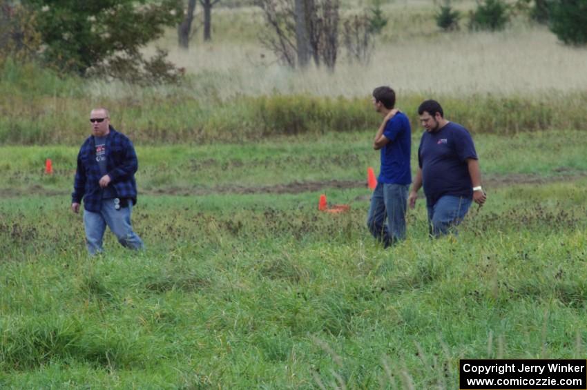 Dan Drury and two others walk the course