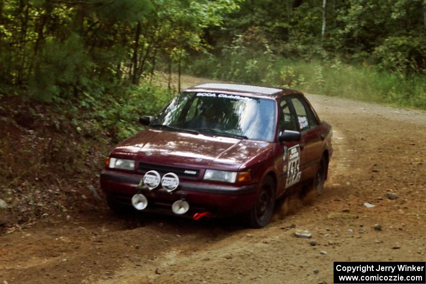 Ben Hanka / John Nordlie Mazda Protege at a 90-right on SS13, Indian Creek.