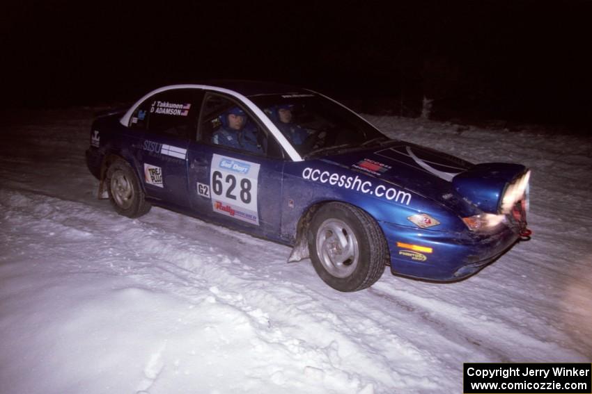 The Dan Adamson / Jason Takkunen Saturn SL2 drifts through the first corner of the evening running of the ranch stage.