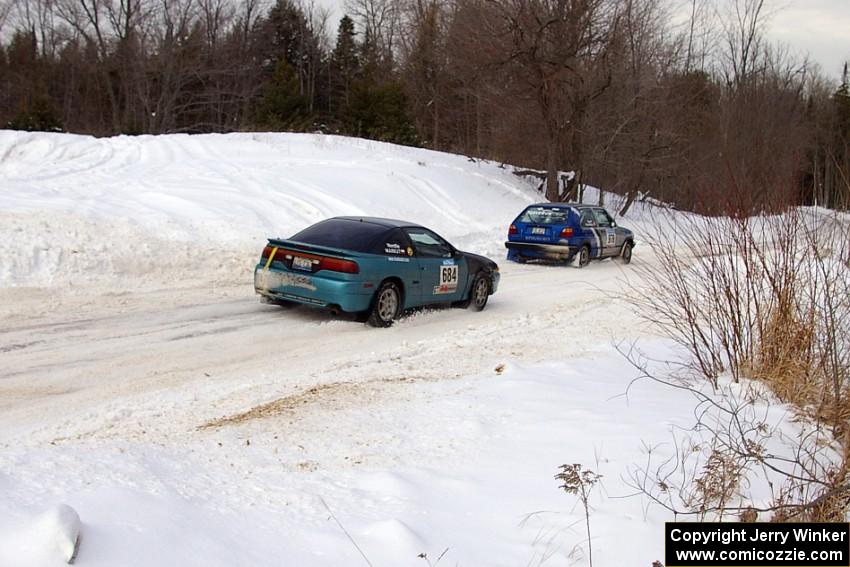 Adam Markut / John Nordlie Eagle Talon passes the Russ Rosendale / Pete Oppelt VW Golf on a straight just after a 90-right.