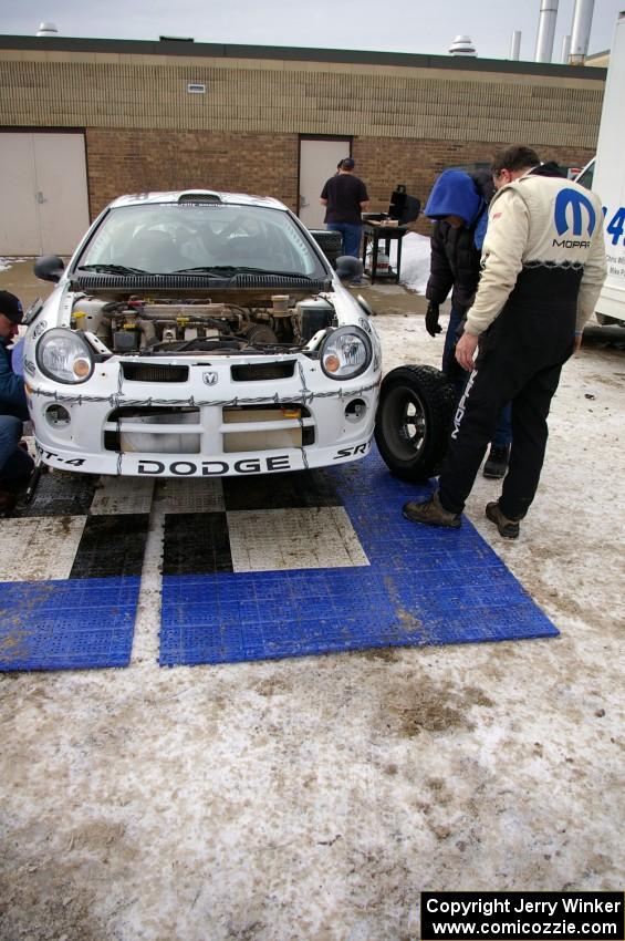 Doug Shepherd examines the left-front tire of his Dodge SRT-4 at the final service in Atlanta. He shared the car with Bob Martin