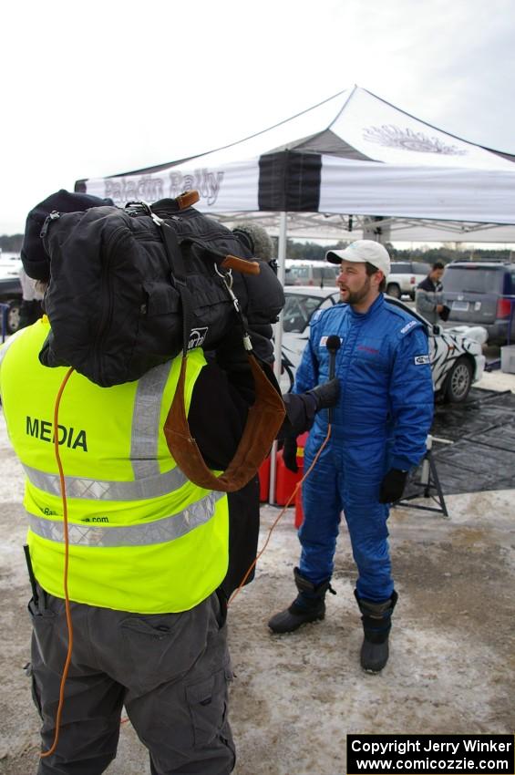 Navigator Ole Holter is interviewed in front of the Subaru Impreza that he shared with driver Matt Iorio.