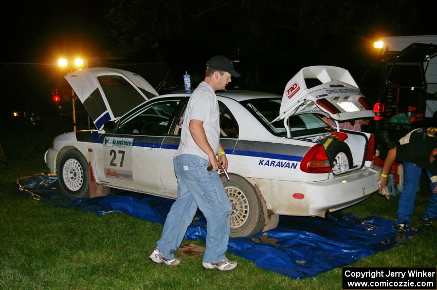 Chris Gilligan / Joe Petersen Mitsubishi Lancer Evo IV gets serviced in Akeley after the first set of stages.