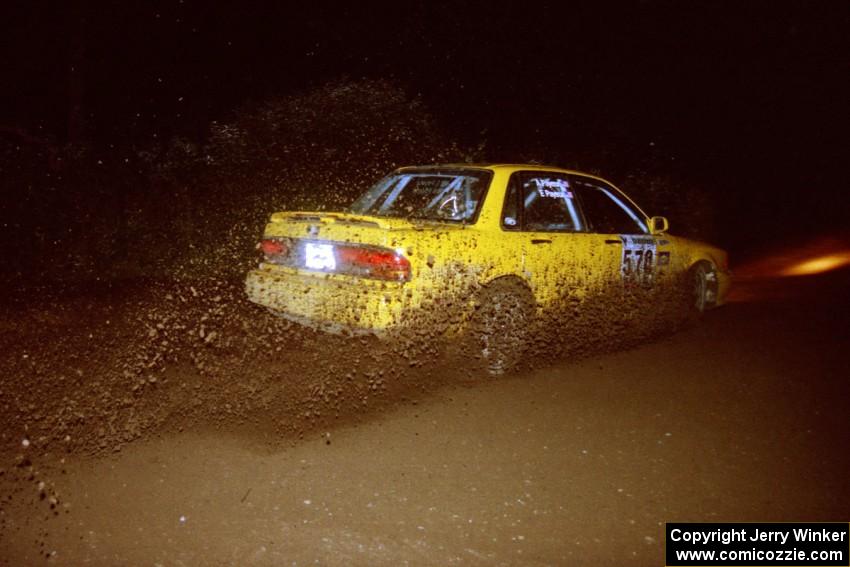 Erik Payeur / Adam Payeur Mitsubishi Galant slings gravel through a 90-left on SS7, Blue Trail.