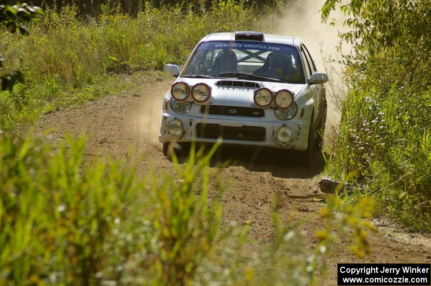 Fintan McCarthy / Noel Gallagher Subaru WRX STi at speed through a downhill left on SS10, Chad's Yump.