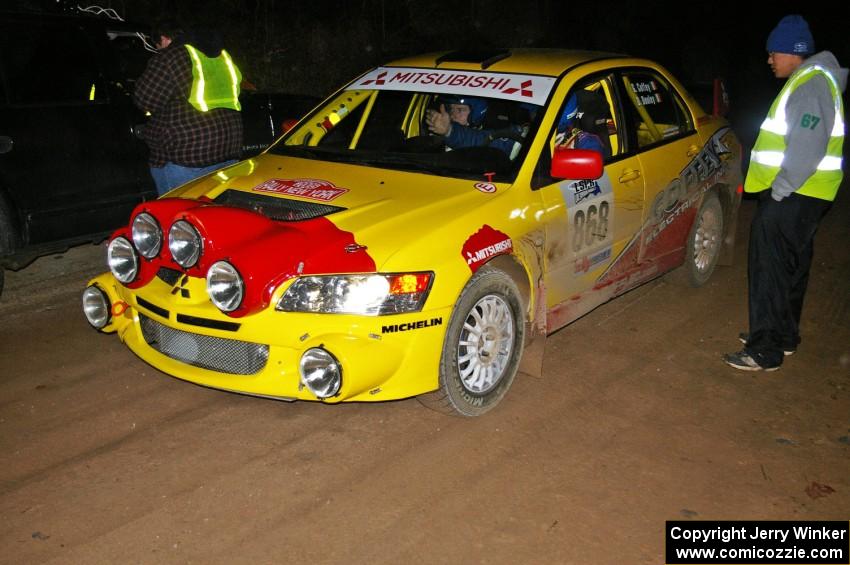 Russ Johnson talks to Gerry Coffey / Dave Dooley Mitsubishi Lancer Evo 8 at the finish control of SS4, Baraga Plains.