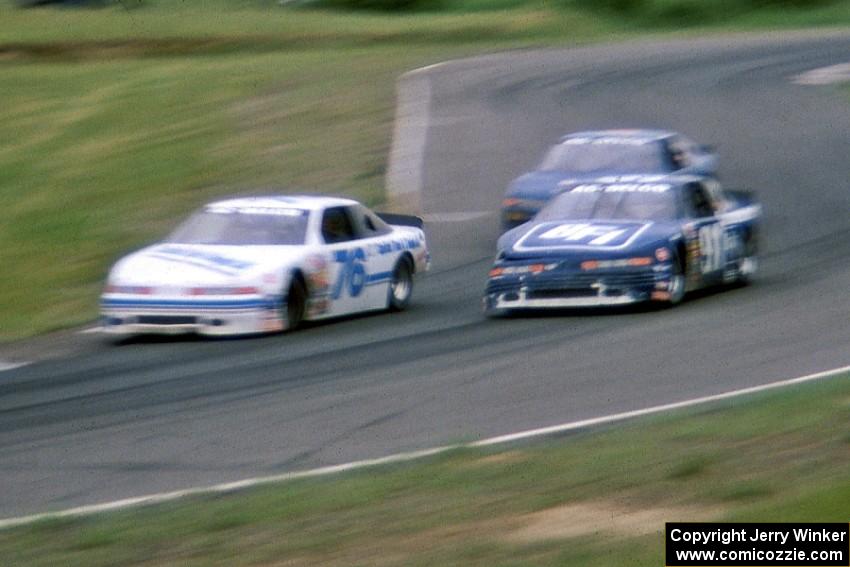 John Cadman's Olds Cutlass Supreme and Tom Harrington's Olds Cutlass Supreme go through turn 8