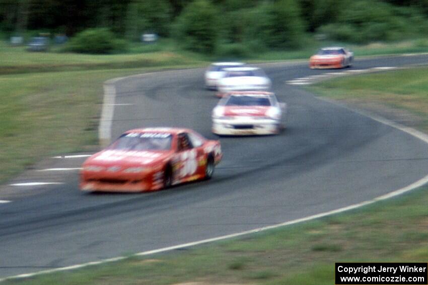 Brett Bell's Ford Thunderbird leads a pack through turns 7/8