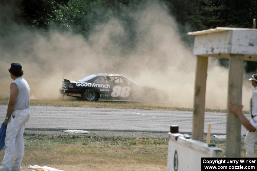 Mike Eddy's Pontiac Grand Prix gets refired at the outside of turn 3