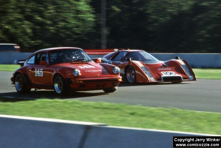 A Porsche 911 is passed by a McLaren M6B GT through Thunder Valley.