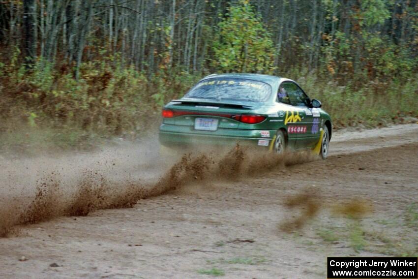 Tad Ohtake / Bob Martin drift their Ford Escort ZX2 through the first corner of Menge Creek I.