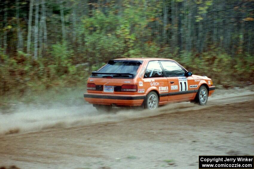 Gail Truess / Nancy Redner drift their Mazda 323GTX through the first corner of Menge Creek I.