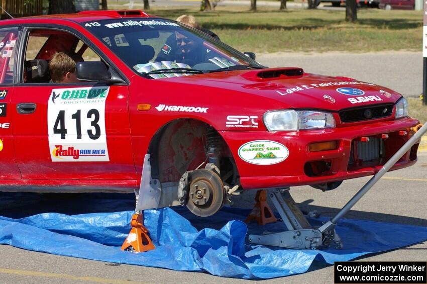 Erik Schmidt / Mike Rose Subaru Impreza receives repairs at parc expose.