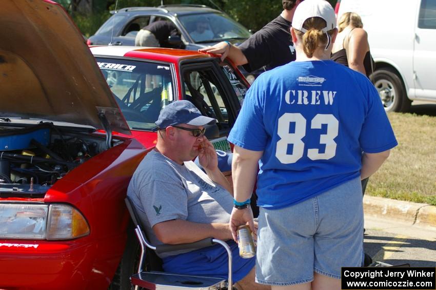 Mary Utecht, Mark Utecht, and Mike Hurst take a breather in front of Mark's Ford Mustang at parc expose.