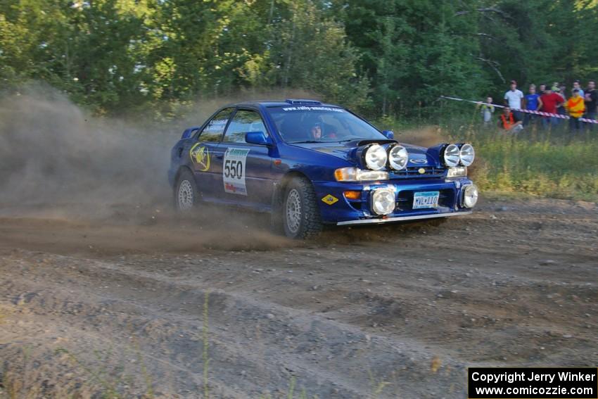 Kyle Sarasin / Stuart Sarasin drift through a 90-right at the SS14 spectator point in their Subaru Impreza.