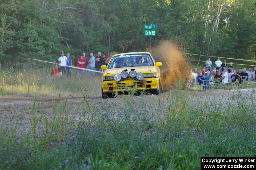 Erik Payeur / Adam Payeur throw a wave of gravel skyward at the spectator point on SS14 in their Mitsubishi Galant.