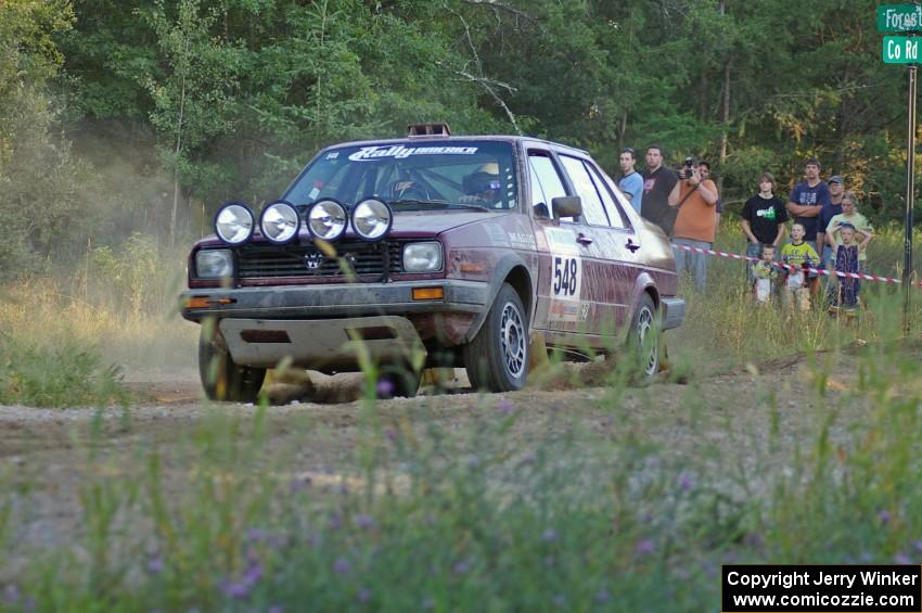 Matt Bushore / Karen Wagner drift past the throng of spectators at SS14 in their VW Jetta.