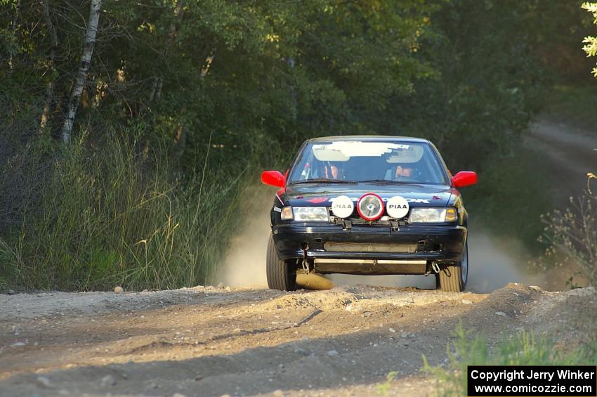 Scott Justus / Dave Parps come out of the woods and onto the county road on SS14 in their Nissan Sentra SE-R.