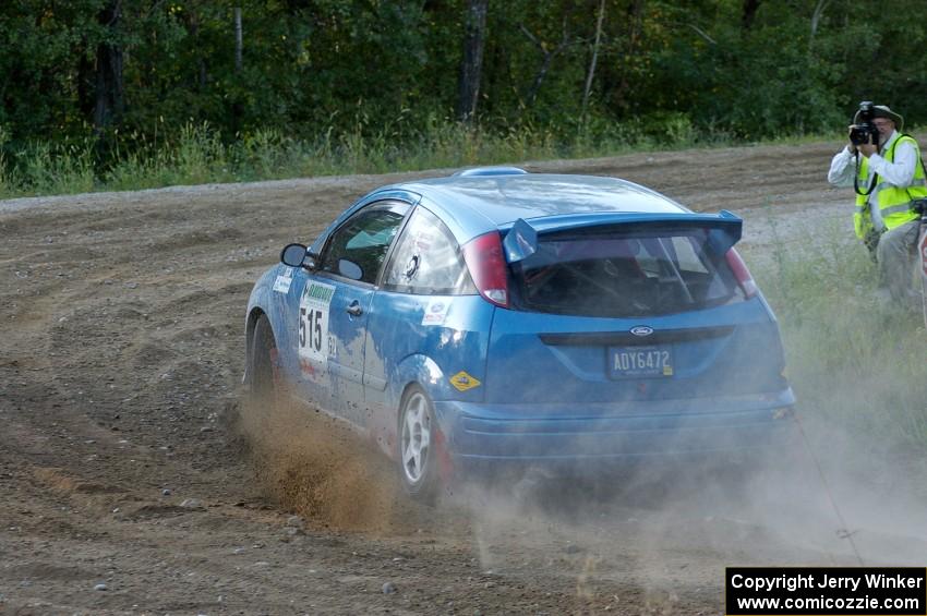 Photographer Ronnie Arnold snaps a shot of Adam Boullion / Phil Boullion Ford Focus at the spectator point on SS14.