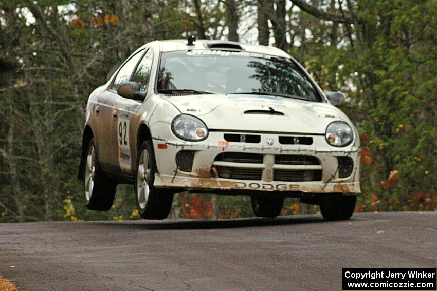 Paul Dunn / Bill Westrick catch minor air over the midpoint jump on Brockway 1, SS11, in their Dodge SRT-4.