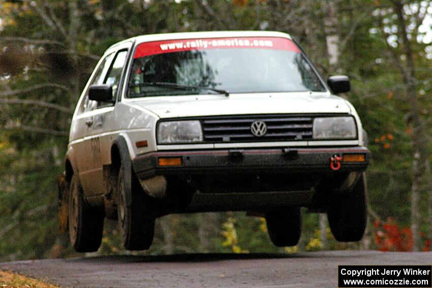 John Hruska / Carl Seidel get a few inches off the ground in their VW GTI at the midpoint jump on Brockway 1, SS11.